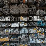 A detailed assortment of metal bars, tubes, and pipes stored on shelves in an industrial setting.
